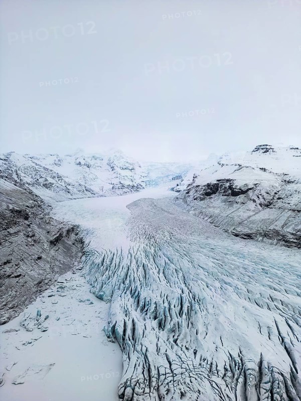 Aerial view of Iceland's winter landscape showcasing vast glaciers and rugged terrain. The frozen beauty captures the wild, remote essence of nature in its cold embrace, Ã–rÃ¦fi, Austurland, Islandia