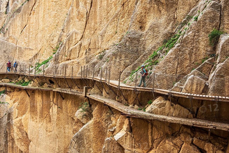 Tourists on the elevated path of the caminito del rey, along a deep gorge, Andalusia, Spain