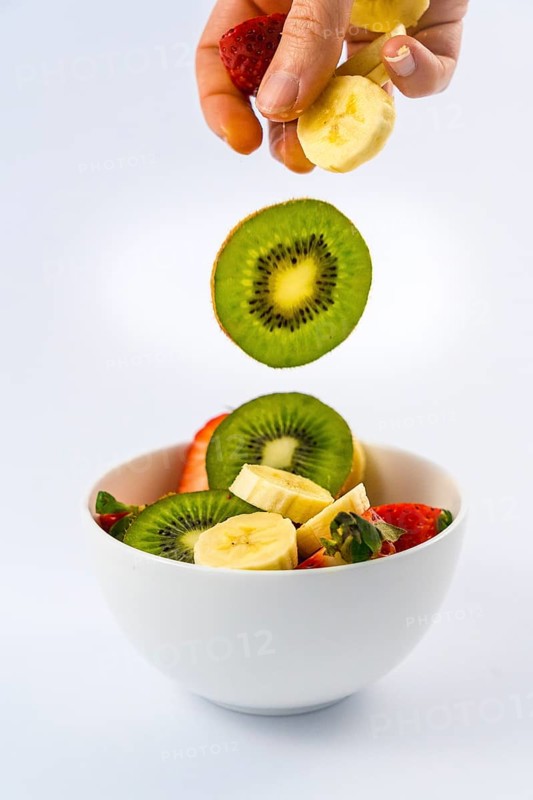 Introducing ingredients, recipe of a fruit salad with kiwis, strawberries, bananas