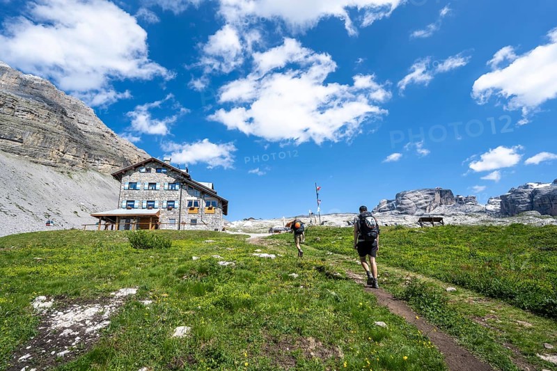 Hikers in front of Rifugio Graffer, Brenta, Brenta-Adamello Natural Park, Trentino, Italy