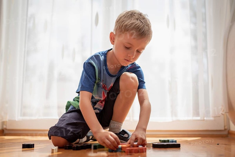 5-6 old boy play with blocks puzzle in Tymowa, Poland