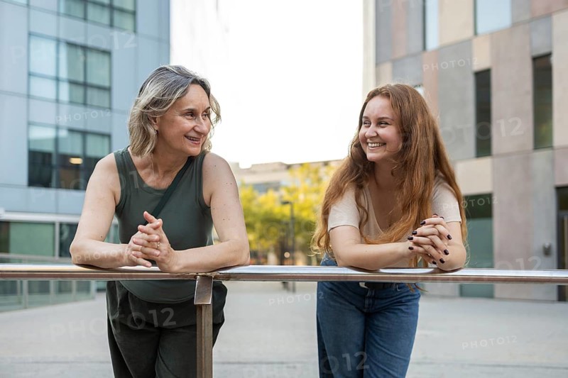 A joyful moment of a mom and daughter enjoying quality time together in a city setting, depicting their close bond and happiness. Perfect for lifestyle and family themes
