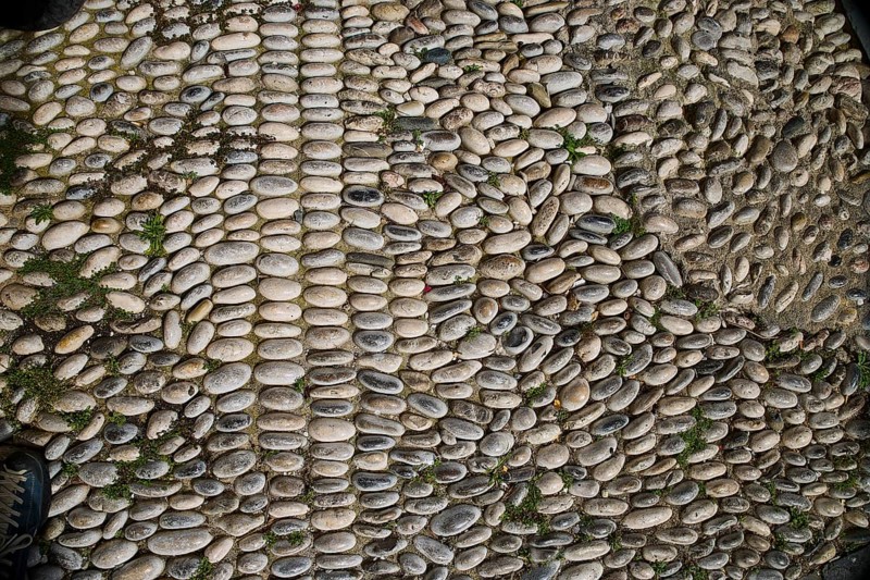 Non-uniform pattern of paving stones with moss and grey tones, Rhodes Old Town, Rhodes, Dodecanese, Greek Islands, Greece