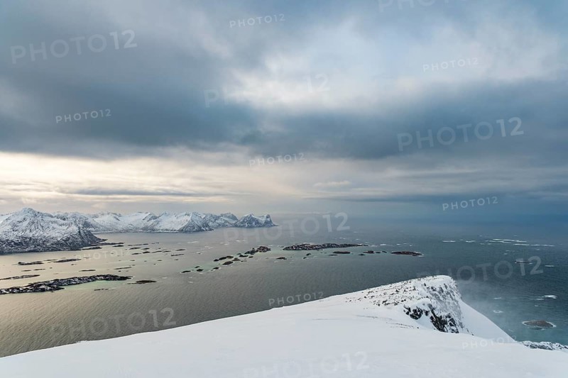 View of the snow-capped mountains of Senja Island and the open sea, Troms, Norway