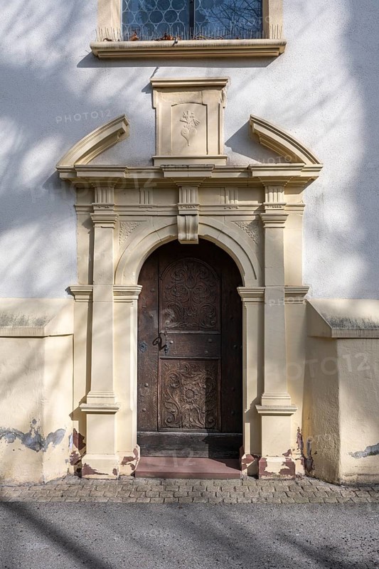 Side portal of the Ruhe-Christi Church with richly decorated wooden door, Rottweil, Rottweil district, Baden-Württemberg, Germany