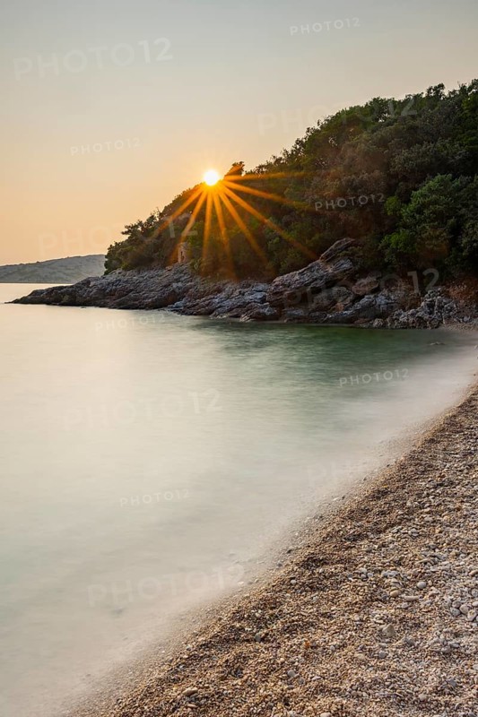 Crystal clear and turquoise water on the beach of Ustrine Bay on a sunny day at sunset on the island of Cres, long exposure, Croatia