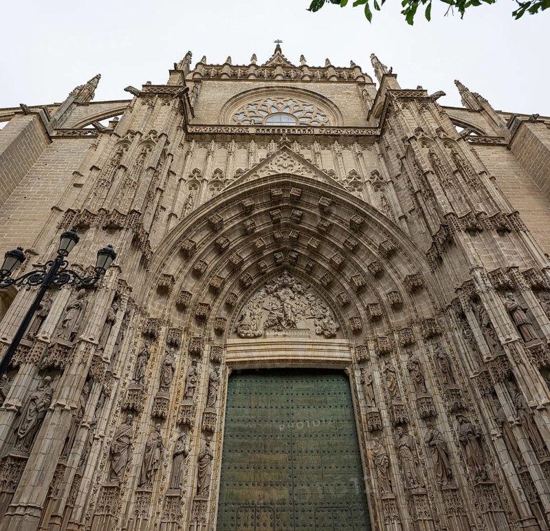 Impressive Gothic façade with detailed portal and richly decorated sculptures, Seville, Andalusia, Spain