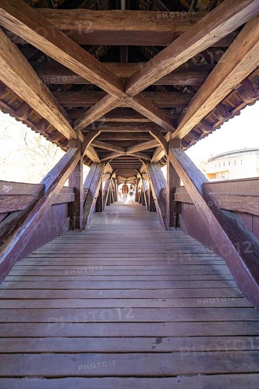 Elongated wooden bridge with visible beams in tunnel view, Schwäbisch Hall, Germany