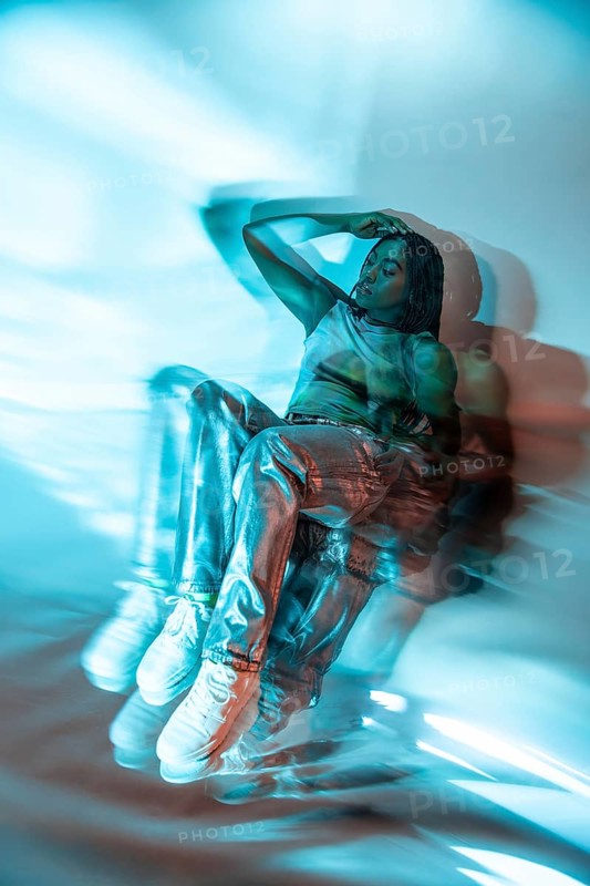 A futuristic African young woman immersed in the metaverse, her figure blurred with digital effects. She embodies the essence of virtual reality and advanced technology