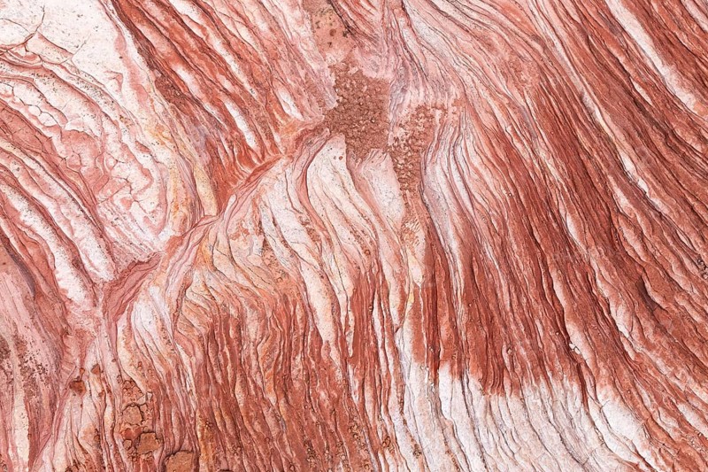 Discover the intricate patterns and rich hues of the desert rock formations at Vermilion Cliffs National Monument, Arizona. The vibrant textures showcase nature's artistic touch