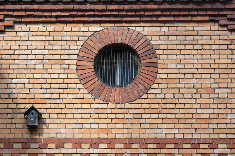 A round window, also called oculus, ox eye in a brick wall, decorated, historic old town of Rottweil, district of Rottweil, Baden-Württemberg, Germany