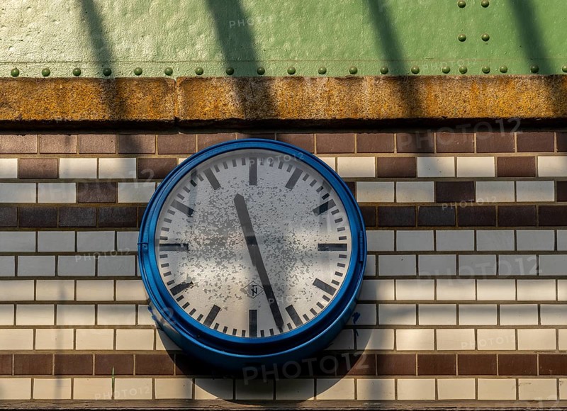 Old station clock on a tiled wall at Lichterfelde West S-Bahn station, Berlin, Germany