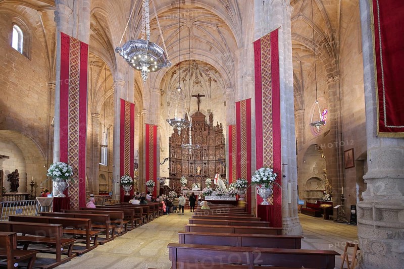 Interior view of Iglesia Concatedral de Santa Maria, church with banners and flags, UNESCO old town, Caceres, Extremadura