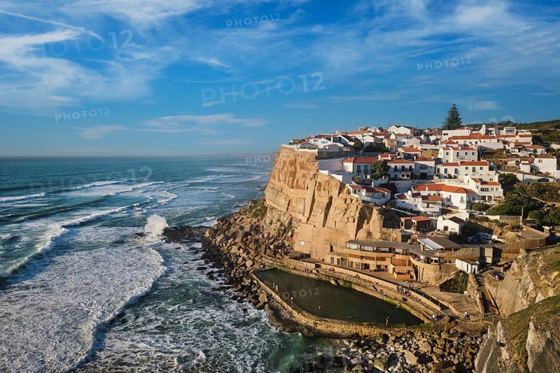 Azenhas do Mar features charming white houses stacked on cliffs overlooking the Atlantic Ocean