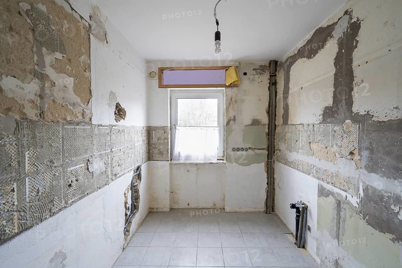 Apartment is being renovated, partly exposed walls, exposed pipes, old building renovation