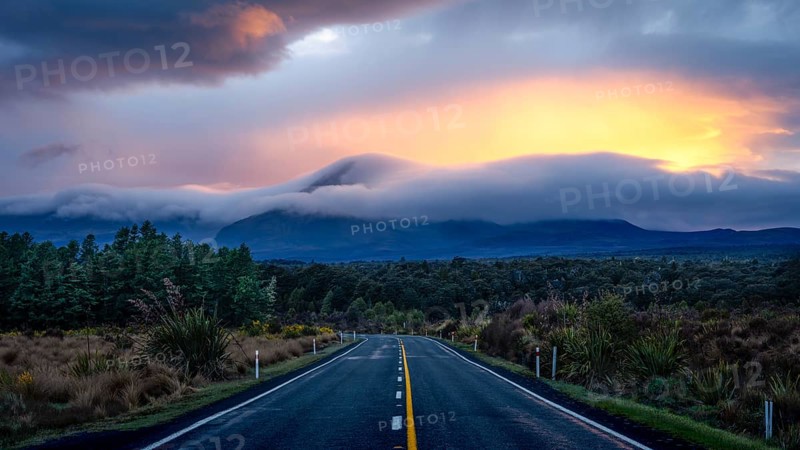 Mount Ngauruhoe in the morning at sunrise with glowing clouds, road SH 47. Tongariro National Park, North Island, New Zealand