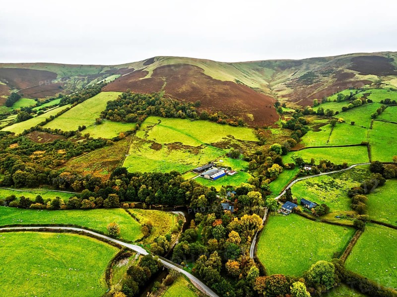Autumn colours of Farms over River Wye and Road A470 from a drone, Llanidloes, Powys, Montgomeryshire, Wales, UK