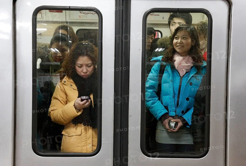 Beijing, CHN, 19.02.09 — Chinese passengers on a crowded subway in Beijing, CHINA
