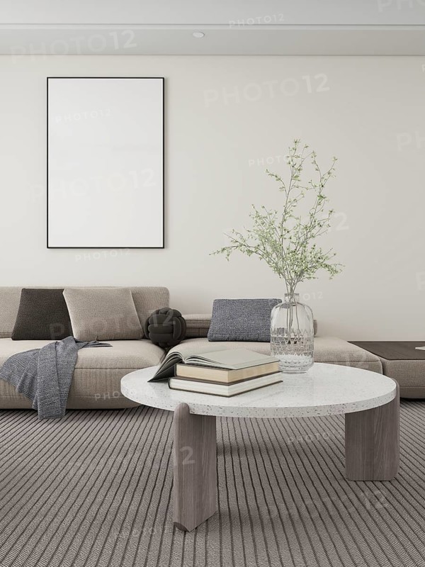 Modern living room with neutral tones, featuring a cozy sofa, decorative cushions, and a stylish coffee table with books and a vase. Ideal for minimalist and elegant designs