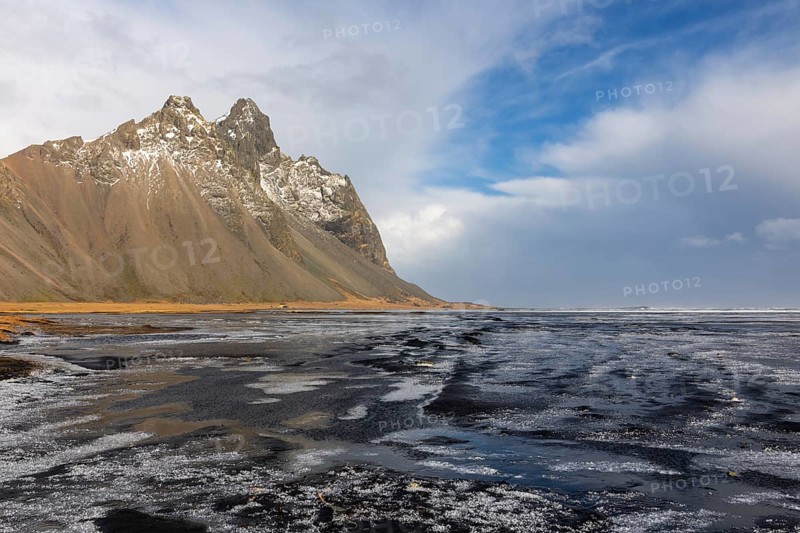 Teared water on lava sandy beach against mountain backdrop, sea, snow, winter, Stokksnes, Vestrahorn, Klifatindur, Höfn, Iceland, Scandinavia