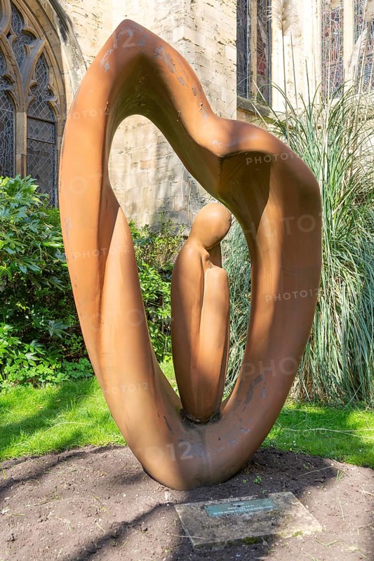 Sculpture by artist Naomi Blake 1980 'Refugee' garden of Bristol cathedral church, Bristol, England, UK