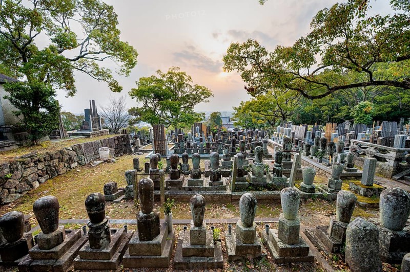 Tombstones at cemetery at sunset, Konkai-Komyoji Temple, Kurodanicho, Kyoto, Japan