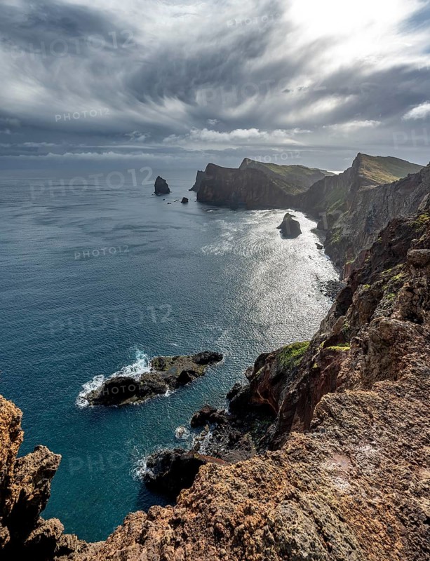 Red cliffs and rocks in the sea, coastal landscape with dramatic sky, Ponta de São Lourenço, volcanic peninsula São Lourenço, Ponta de San Lorenzo, Madeira, Portugal