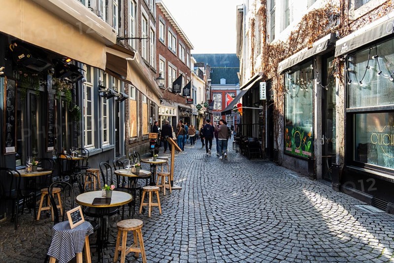Alley with cafes and shops in the old town of Maastricht, the Netherlands