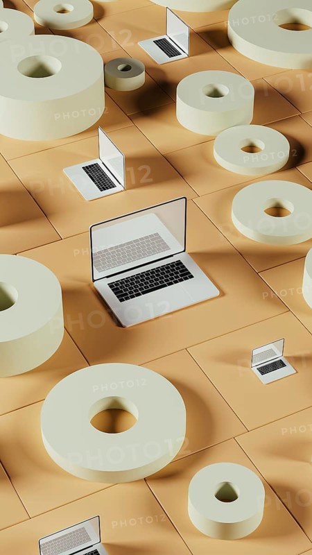 Amidst a backdrop of geometric shapes, a laptop rests on a flat surface, showcasing a blend of modern technology and abstract design