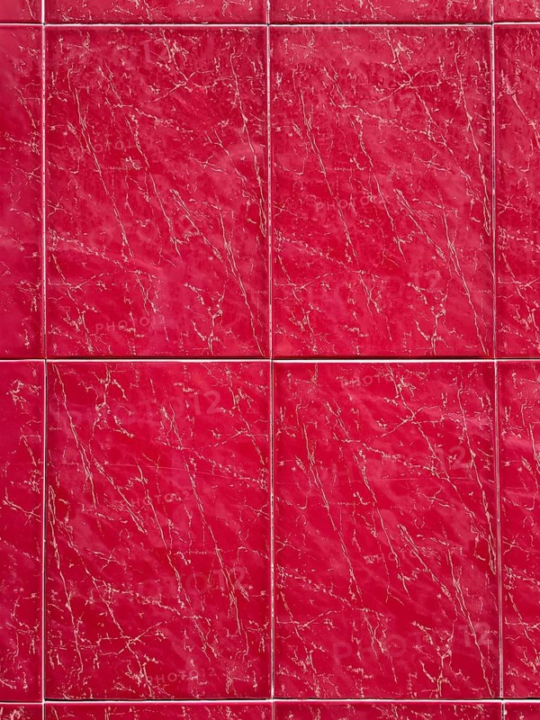 Close-up view of deep red marble tiles featuring a natural veining pattern. The vibrant color and distinct lines create a luxurious and elegant aesthetic perfect for interiors
