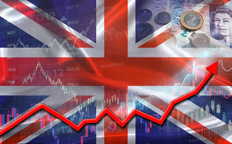 United Kingdom economic growth on financial graph. Financial market growth with the British flag in the background of financial statistics