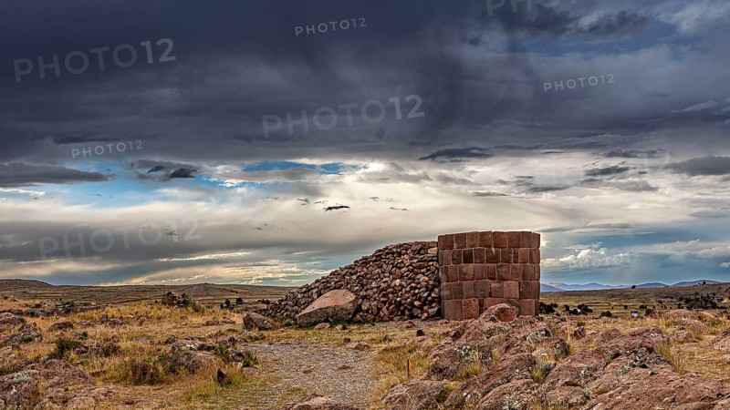 Historic stone structure against dramatically cloudy sky, The Chullpas of Sillustani near Puno in Peru