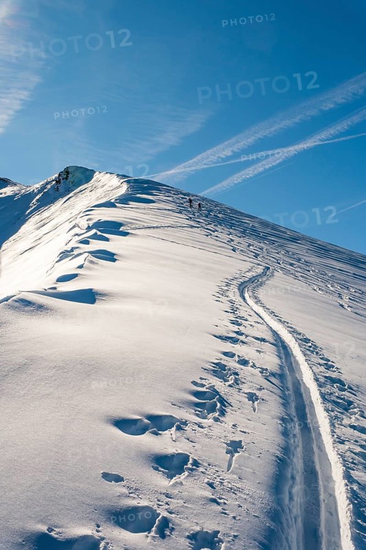 Trail of ski tourers next to a snowfall, small grater, Berchtesgaden National Park, Schönau am Königssee, Berchtesgadener Land, Upper Bavaria, Bavaria, Germany