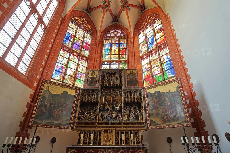 High altar with colorful church windows, candles, paintings, stained glass, handicrafts, choir window, interior view, pilgrimage church, Klausen, Moseleifel, Eifel, Rhineland-Palatinate, Germany
