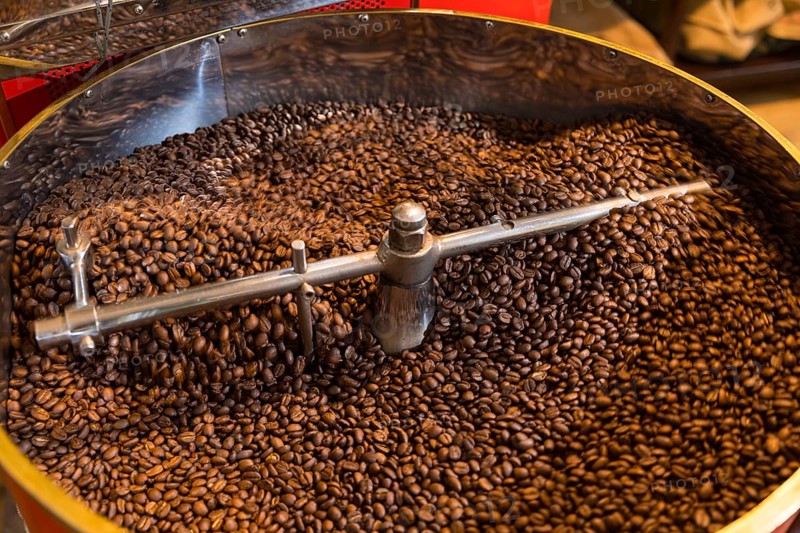 Coffee is roasted by hand in a small drum roaster with lots of experience, where the hot freshly roasted coffee beans cool down using air in a sieve, Kaffeerösterei Müller, Wildenhain, Großenhain, Saxony, Germany