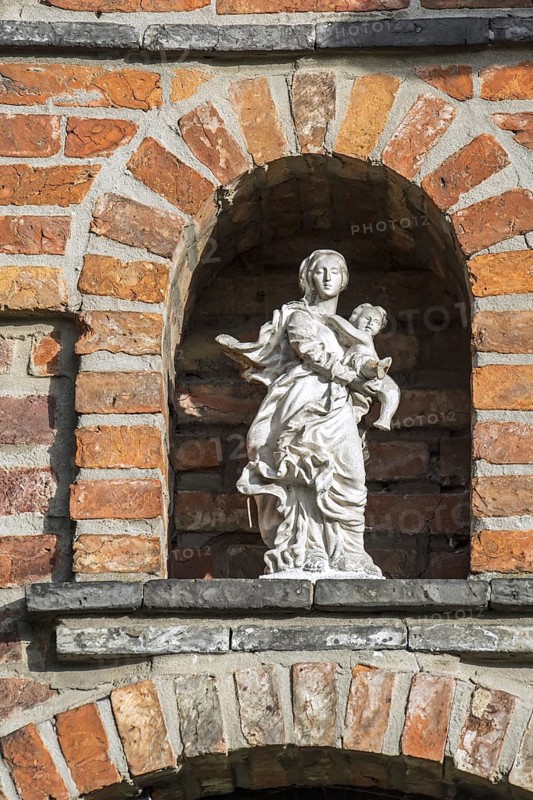 Statue of Virgin Mary with Baby Jesus in alcove above entrance door at the 17th century Beguinage of Aarschot in Flemish Brabant in Flanders, Belgium