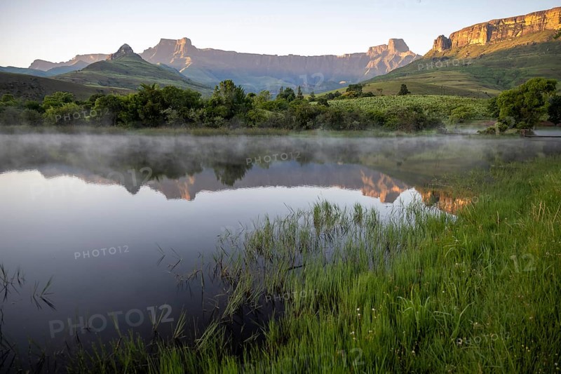 Sunrise, amphitheatre with reflection in the lake, Royal Natal National Park, Drakensberg Mountains south, Kwa Zulu Natal, South Africa
