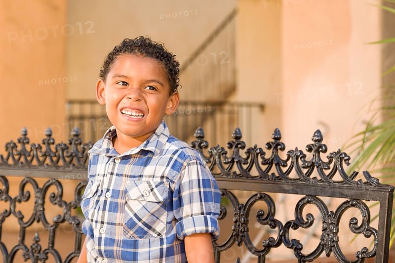 Handsome African American and Mexican Boy Sitting on Park Bench