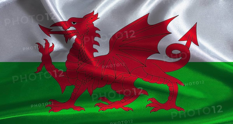 Wales flag with cloth textured background. National flag of Wales with realistic texture