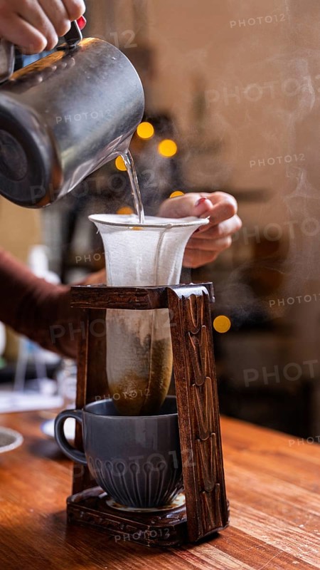 Experience a cozy cafe vibe with this artisanal coffee-making process. Hot water is poured through a cloth filter, capturing the essence of handcrafted brewing