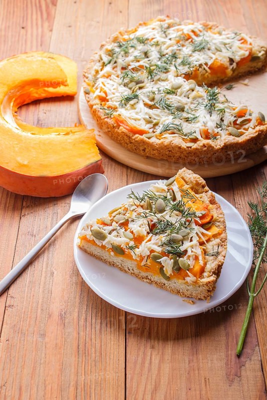 Sweet pumpkin pie with cheese and dill on brown wooden background. top view. copy space