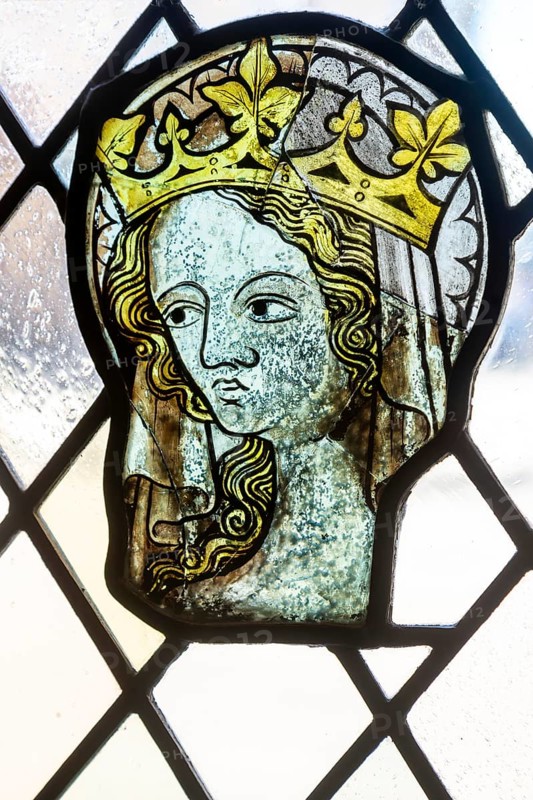 Stained glass window depiction of medieval woman face, Bristol cathedral church, Bristol, England, UK