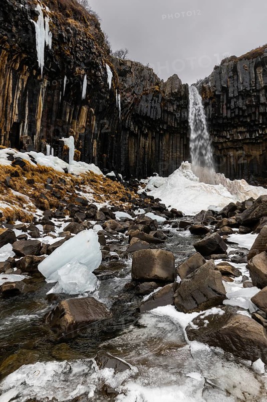 Waterfall, stream, basalt columns, snow, ice, winter, Svartifoss, Iceland, Scandinavia