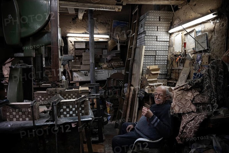 Damascus, Syria. December 10th 2025. Syrian artisan and master craftsman Abu Toni sitting inside his workshop in the Christian quarter of Damascus Old City, Syria