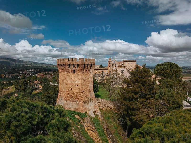 A captivating view of a historic tower and nearby buildings in Treia, Italy. Lush greenery and a vibrant sky create a stunning backdrop, highlighting the town's rich heritage, San Marco, ????, ????????, ??????