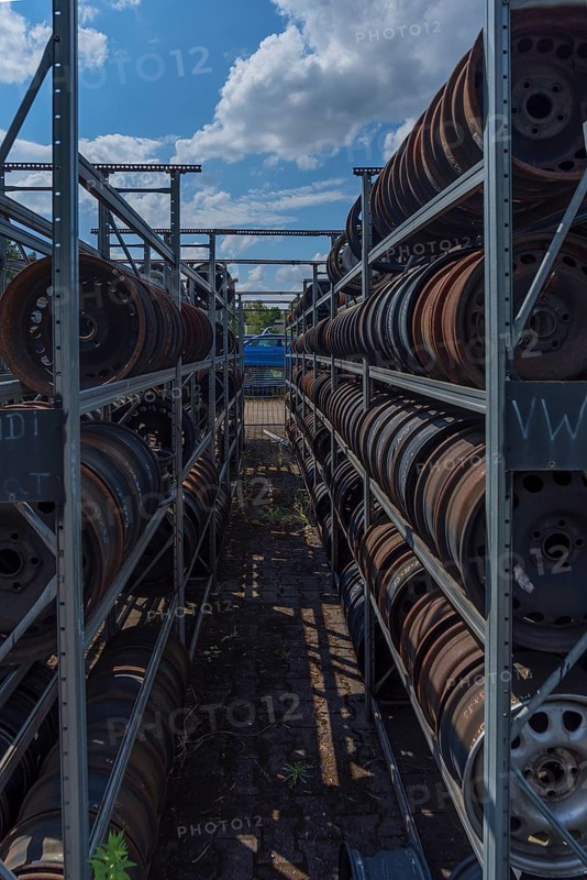 Shelf storage with sorted car rims at a scrap yard, Bavaria, Germany