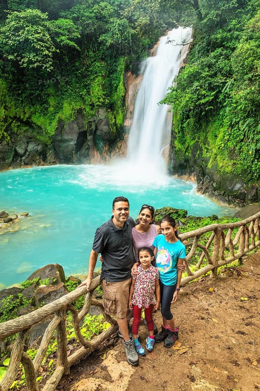 Family at the waterfall at Rio Celeste, Tenorio National Park, Alajuela, Costa Rica, Central America