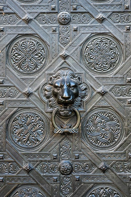 Artfully decorated bronze door with lion's head as a door puller or door knocker on the Gallus portal at the northern transept of Basel Cathedral, Old Town, Basel, Canton of Basel-Stadt, Switzerland