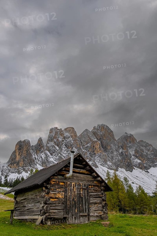 View of a part of the Geisler group from the Gampenwiese, in the foreground an alpine hut, Dolomites, snow, Puez-Geisler nature park Park, St. Magdalena, Funes, Villnößtal, South Tyrol, Italy
