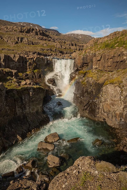 Fossardalur Waterfall with rainbow, close to Djupivogur at the Berufjord, Easter Iceland